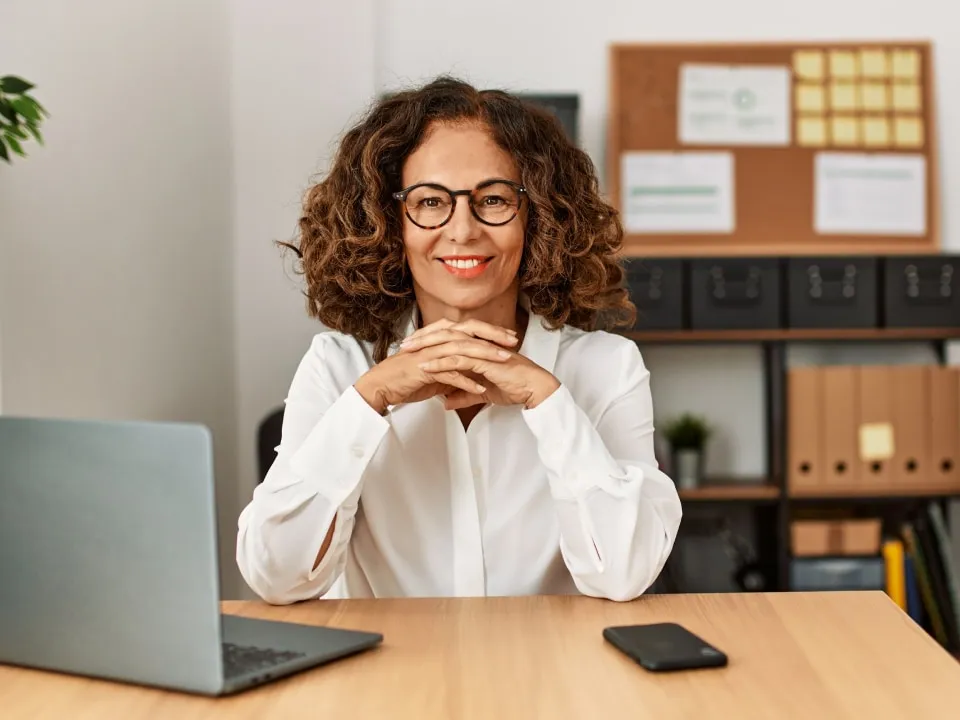 woman smiling behind desk