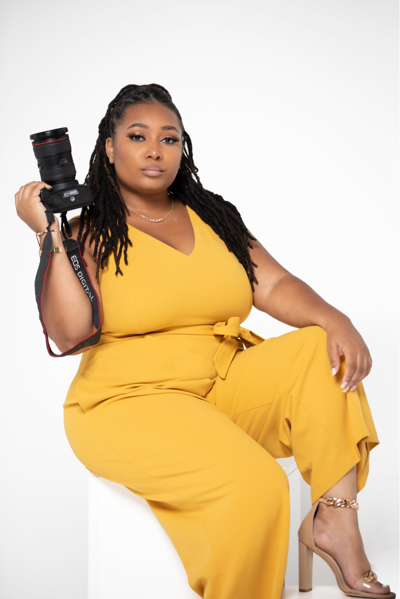 NaKeitha Melton, founder and owner of NaKeitha K Creative Services, poses with her camera.