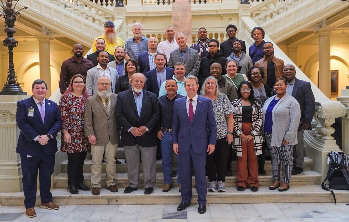 Chasty Wilson (first row, second from right) and her husband and business partner Steven Wilson (third row, far right) visit the Georgia State Capital with the Conditioned Air Association of Georgia.