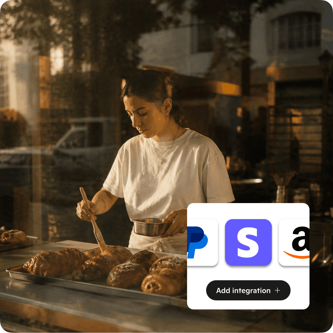 A baker buttering baked goods in her shop